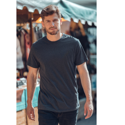 Man wearing a dark gray t-shirt in an outdoor setting with tents and people in the background